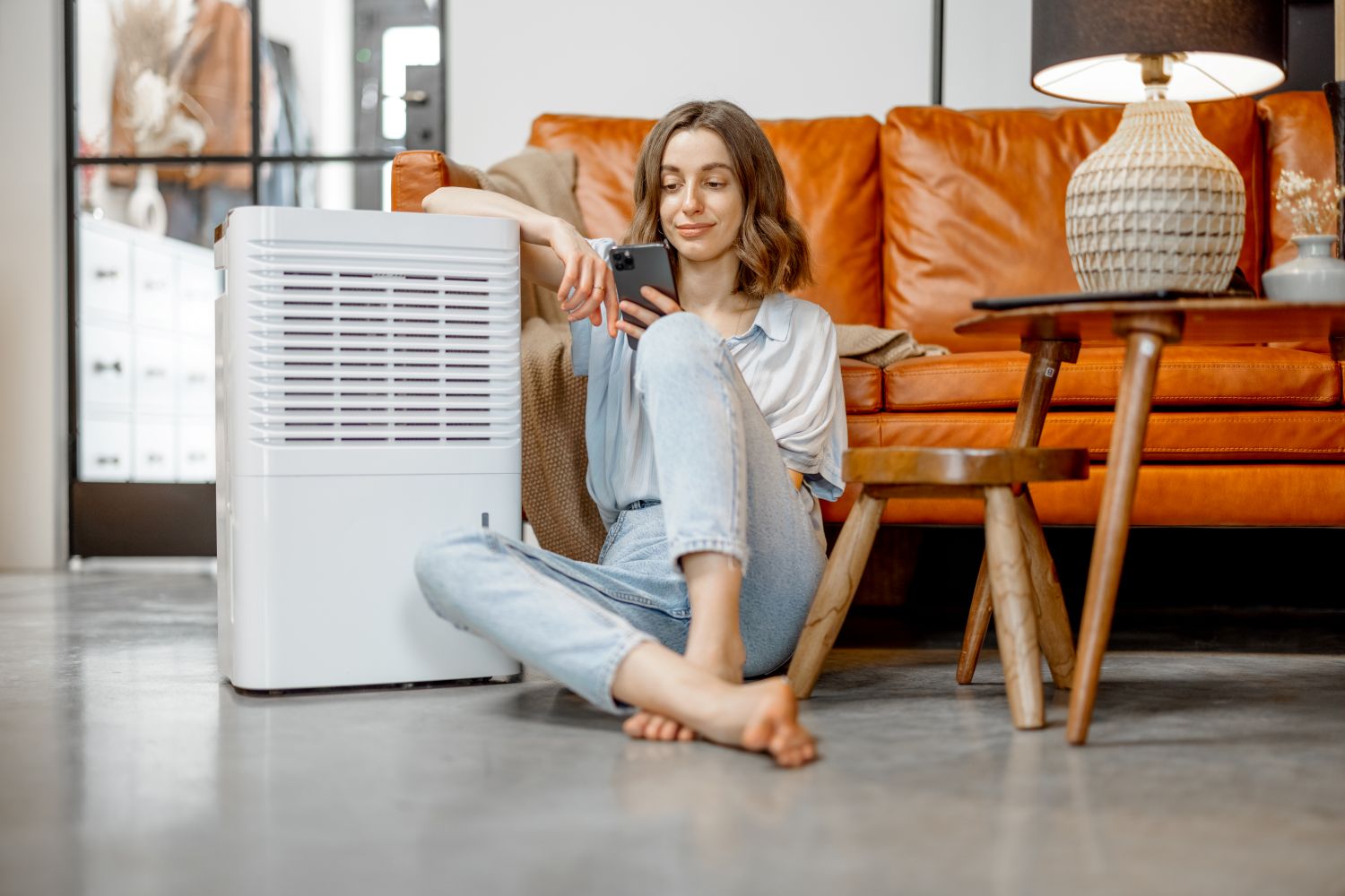 woman sitting next to air humidifier